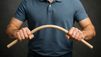Photorealistic image showing a man’s torso from chest to hips, gripping a wooden dowel with both hands and bending it to illustrate the concept of strength through flexibility — “bend, don’t break.”