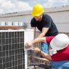 HVAC technician working on commercial rooftop unit representing the growing technician shortage