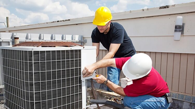 HVAC technician working on commercial rooftop unit representing the growing technician shortage